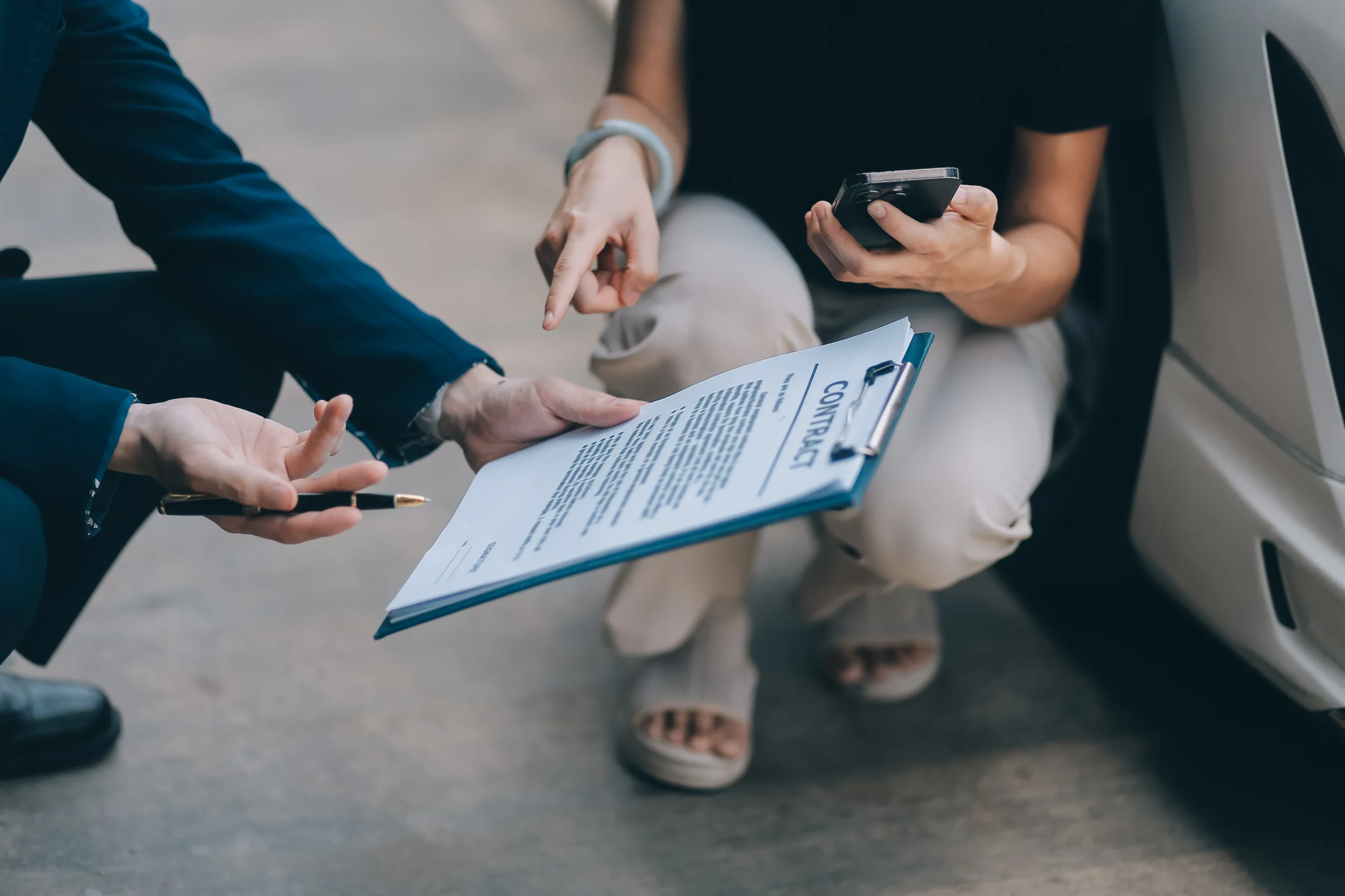 A young businesswoman is navigating car insurance options at her desk, considering premiums, deductibles, and coverage while understanding policies and managing claims efficiently.